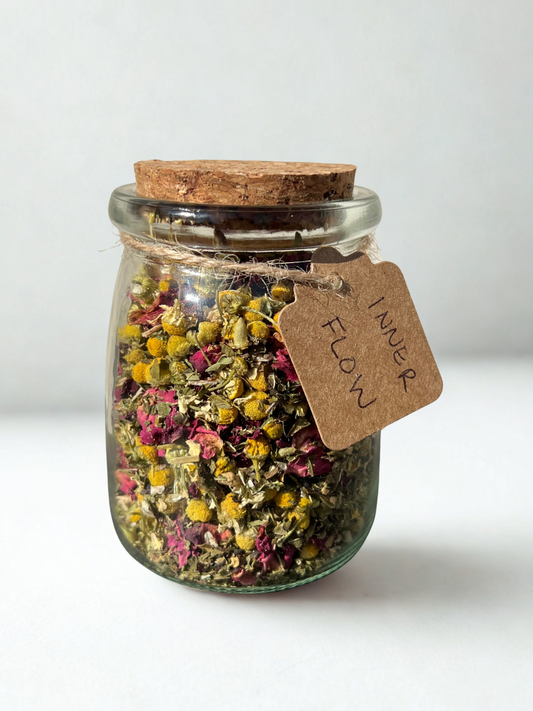 close-up of inner flow herbal tea in 7oz glass jar — a cramp-soothing blend with peppermint, ginger, and chamomile for menstrual comfort and flow support
